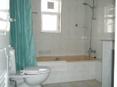 Clean and bright bathroom with shower curtain