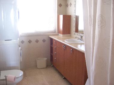 main bathroom with washer and dryer, bathtub & shower
