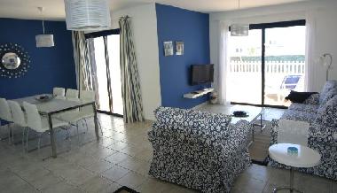 Living and dining area with patio doors leading into the pool