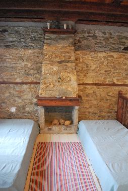 Main room in upper floor, 2 beds, traditional fire place