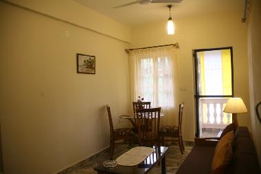 Airconditioned living room with large window and attached balcony for sit out