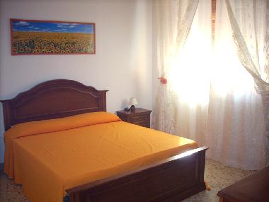 Sunny king-size bedroom.