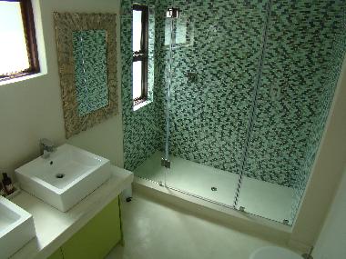 BushGlam second bathroom with two showerheads , two washbasins and toilet
