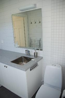 Bathroom/WC with washing maschine, floor heating and shower.