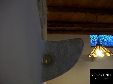 Stone emerging from the wall.