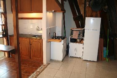 Fully equipped kitchen with cooking utensils and dishes
