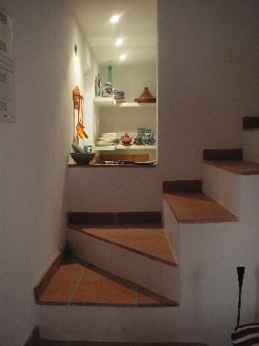 The stairs up with view on the kitchen