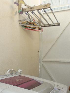 retractable steel hanger behind the kitchen with washing machine