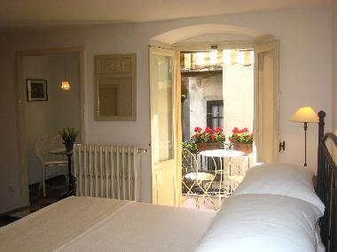 The master bedroom with balcony and private sitting room offers comfort and romance