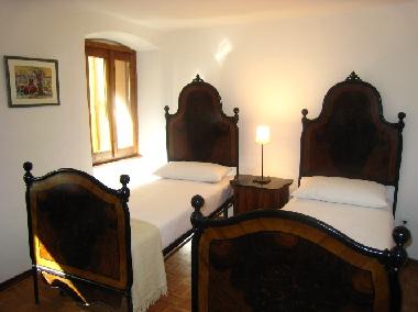 Twin-bedded room features traditionally painted iron `matrimonial` beds can be moved together to for