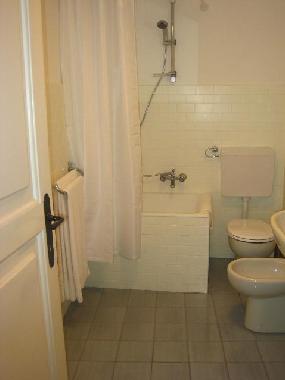 The bathroom is conveniently situated adjacent to the bedrooms, and includes a washing machine