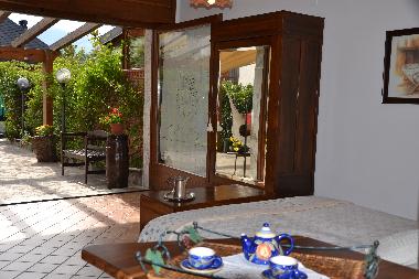 Glimpse of garden from interior of this cosy accommodation in Southern Italy
