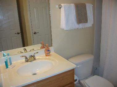 clean bathroom with full set of towels and all necessities of travel