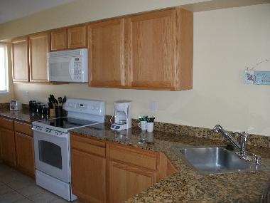 large kitchen with stove/oven, toaster and much cabinet space