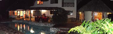 Evening on the veranda at the illuminated swimming pool