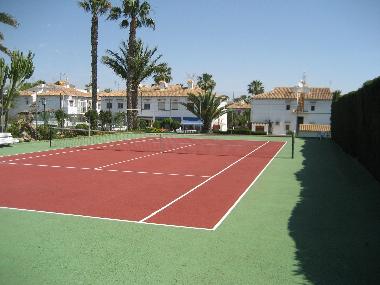 Tennis court with cafetaria at beginning of urbanisation
