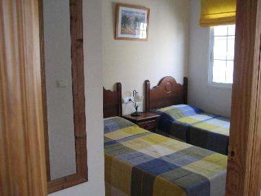 Second bedroom with two single beds and built-in wardrobe