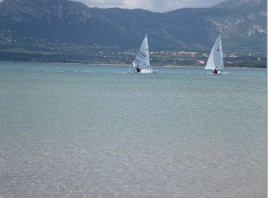 Plage, sable,wind surf,jet ski,bateaux,parasols.