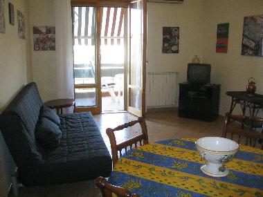 Living room with sofa bed, SAT TV and balcony