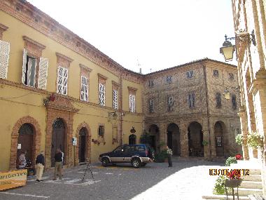 The main square with Palazzo Massi and the bar