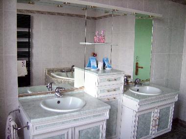 Emerald bathroom, with corner bath and shower, wc, 2 wash basins.