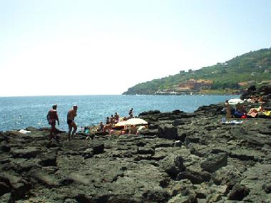 bathers on lava rocks