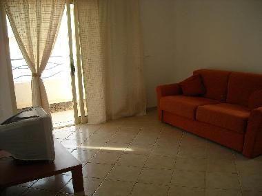 Spacious living room area with sliding double door-.