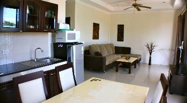 Living room with TV, DVD and fully equipped kitchen.