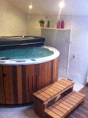 The large jacuzzi in the spa, built into one of the outhouses
