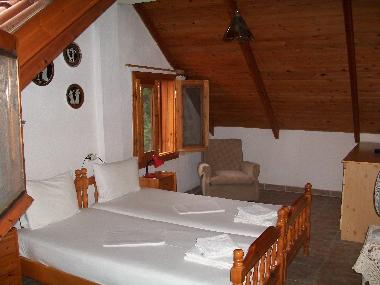 Upper floor room with two single beds