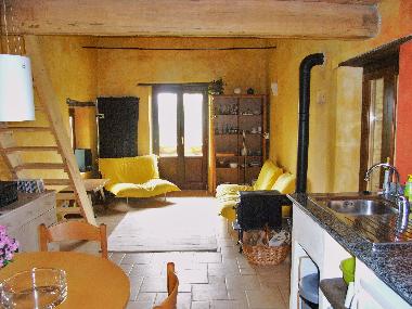 Sitting area on the upper floor. Front door leads to balcony