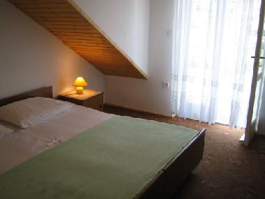 Living room with double bed and terrace which has sea view.