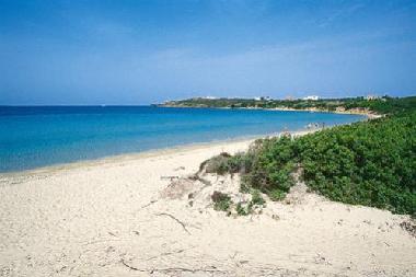 The beach of Le Saline is a wide-sweeping bay that peeps out near the buildings of the salt-works wh