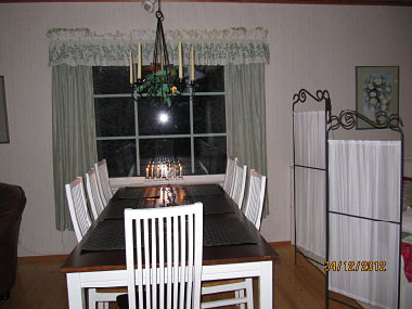 Dining table for 8 persons. The sleeping corner is on the right.