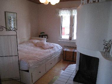 The sleeping corner with a large twinbed.  The open fireplace.