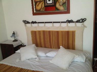 Double bed details wit embroided linen bed. Apartment in Basilicata.