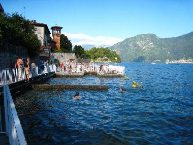 The beach and enclosed swimming area set into the lake at the end of Via Rocco