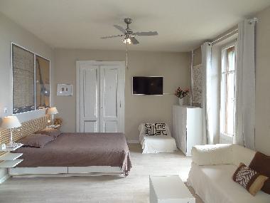 Sleeping area with top-of-the-line Queen Bed, nite stands, reading lamps, single rollaway bed in cab