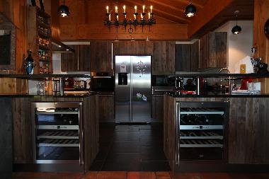 The new kitchen is surounded by a bar and has 2 electric wine caves,