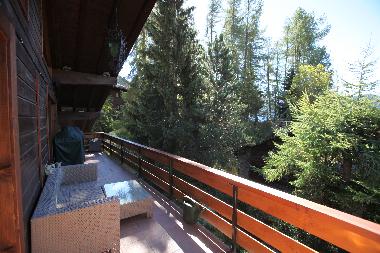 Large lighted terrace with furniture and gas grill