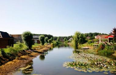 Partial view of the park with a lovely pond and some villa