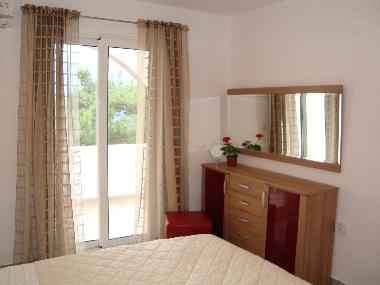 Main bedroom has king size bed and doors to the covered balcony