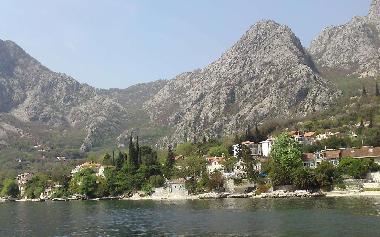 Picturesque fishing village of Orahovac with mountains behind and fjord in front