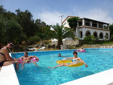 Pool with people and house