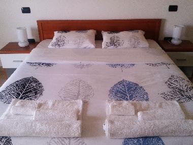 Comfortable double bed in specious modern apartment. Southern Italy