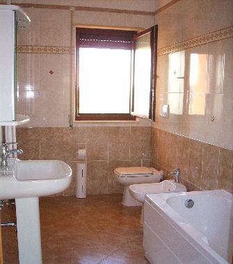 Cozy bathroom with bathtub in holliday apartment. Basilicata, Southern Italy