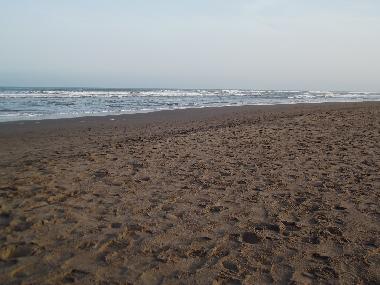 A view of the beach near the house during the sunset