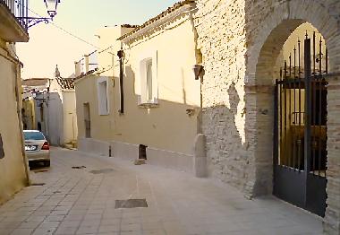 Front of property bathed in bright evening sunshine.