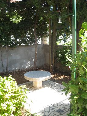 Outdoor shower and small table in the garden