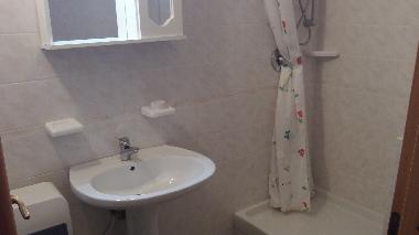 bathroom in one bedroom apartment also has bidet and toilet not visible due to angle